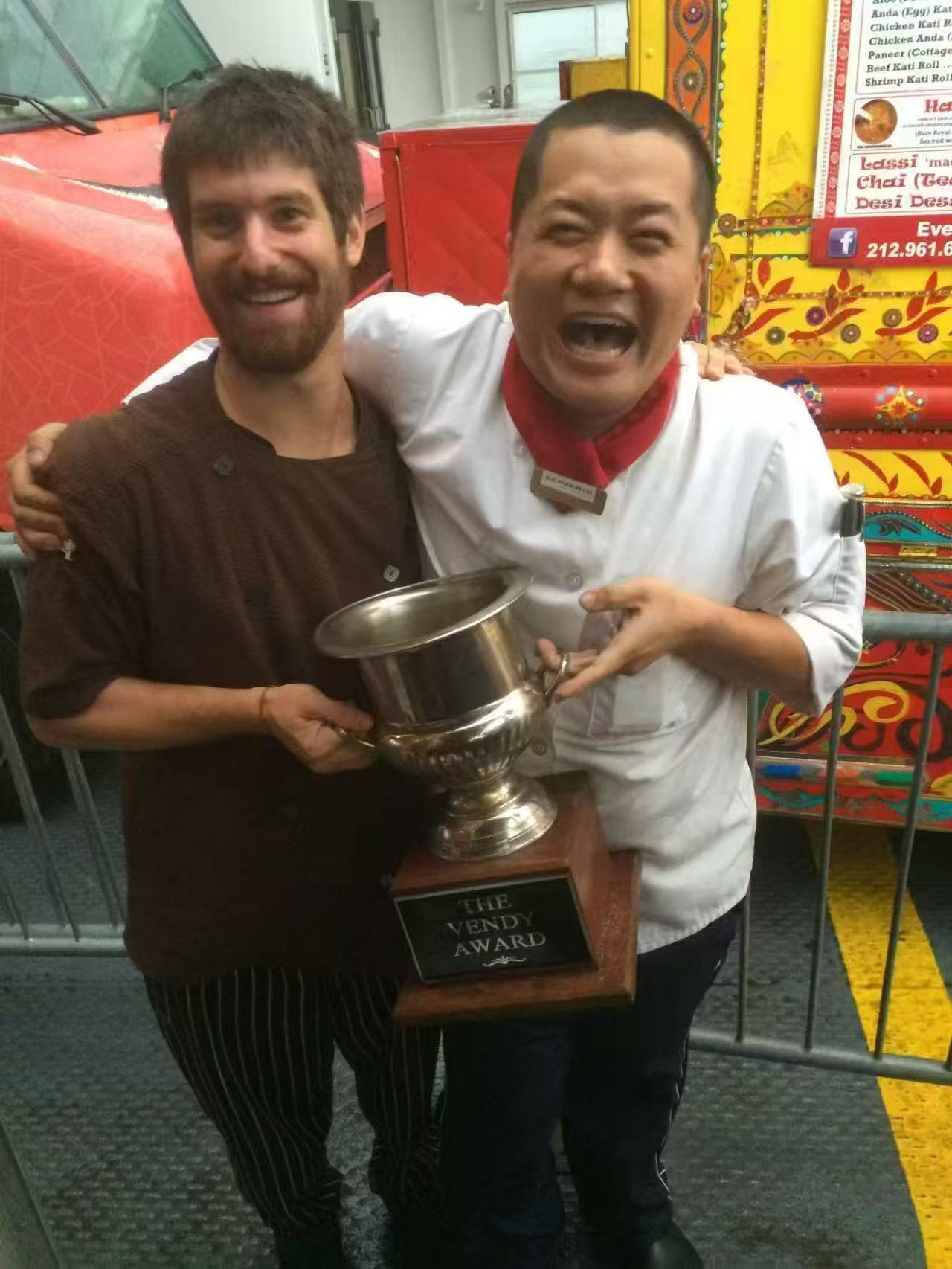 Chef Benjamin holding the Vendy Award trophy, 2014